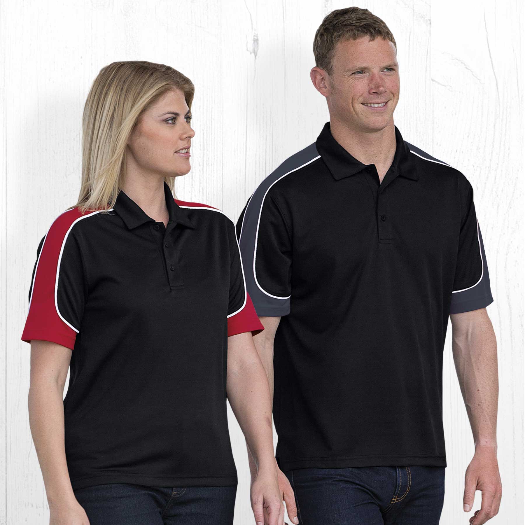 Two models wearing Dri Gear Challenger Polo shirts in black, featuring red and grey accents. The shirts have a logo. Dri Gear Challenger Polo - Image 1