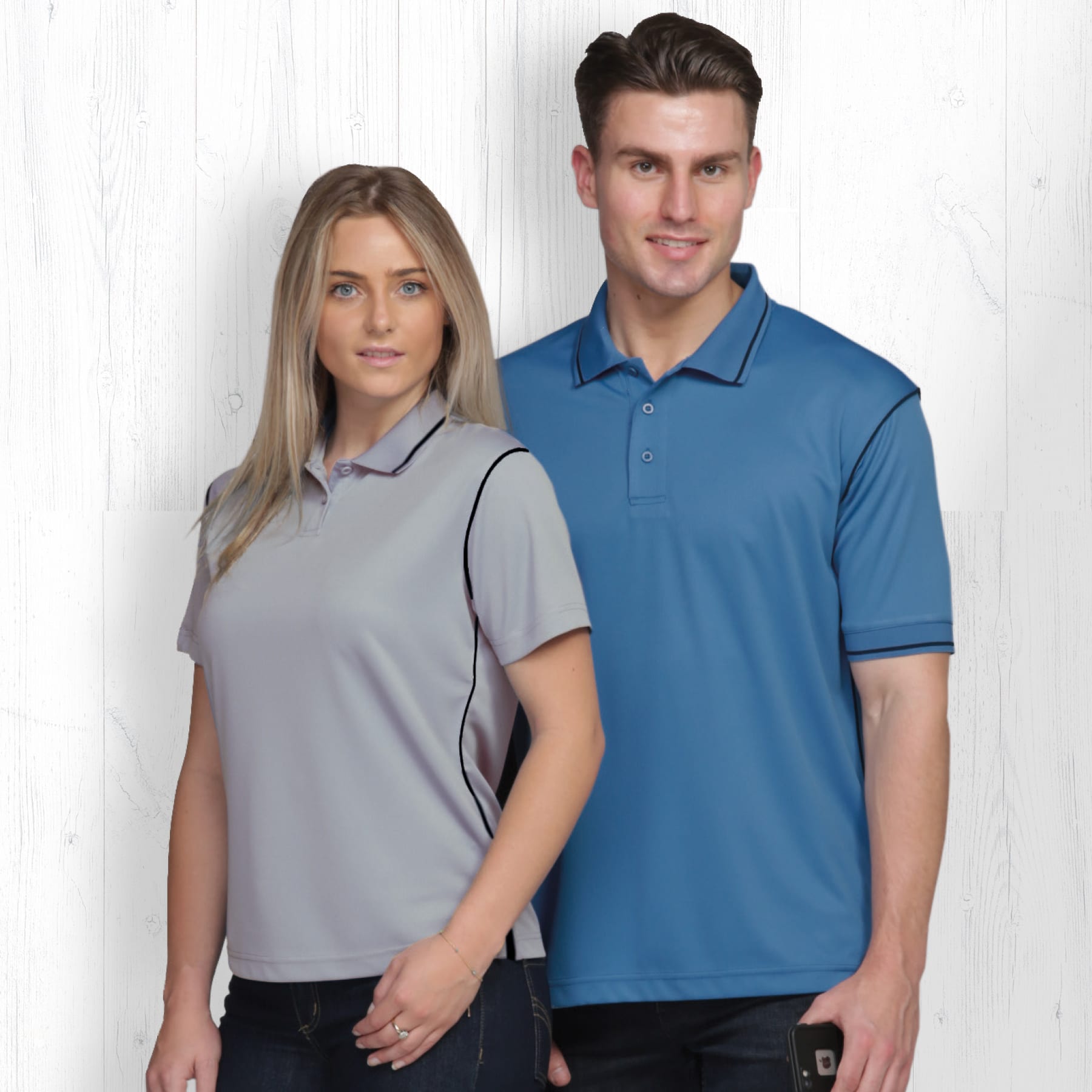 Two models wearing polo shirts in grey and blue, featuring a logo on the chest area. Dri Gear Hype Polo - Mens - Image 1