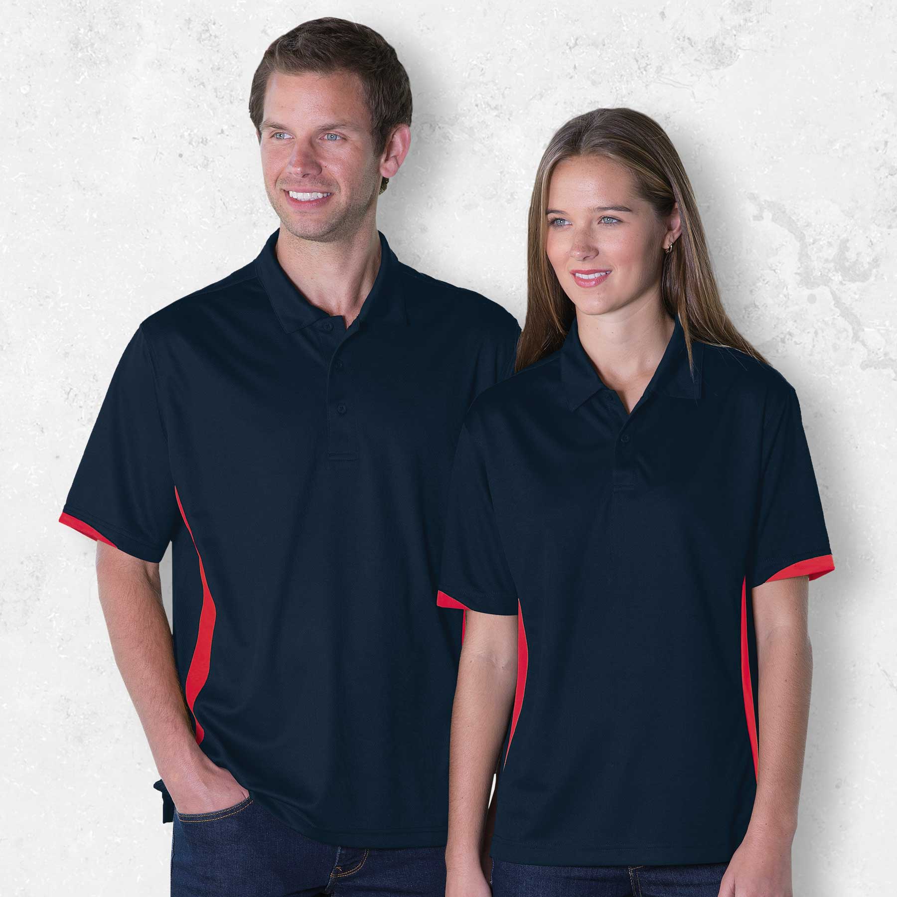 A navy polo shirt with red side accents, displayed on a male and female model. It features a logo on the chest. Dri Gear Zone Polo - Image 1