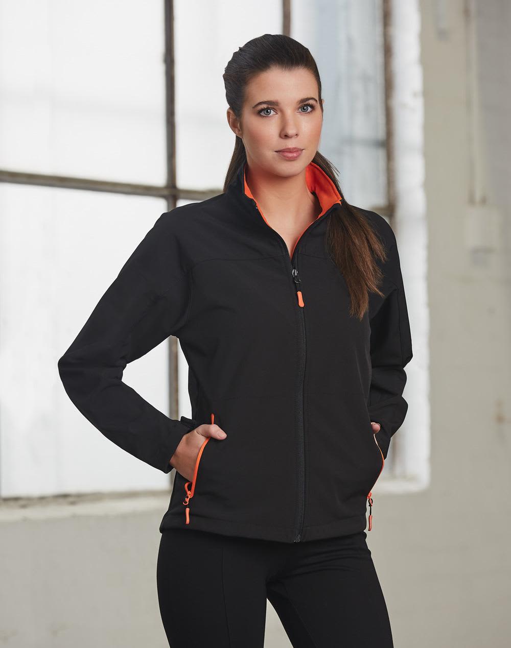 A black softshell jacket with orange contrast detailing, featuring a zippered front and pockets. Ladies' Softshell Contrast Jacket - Image 1