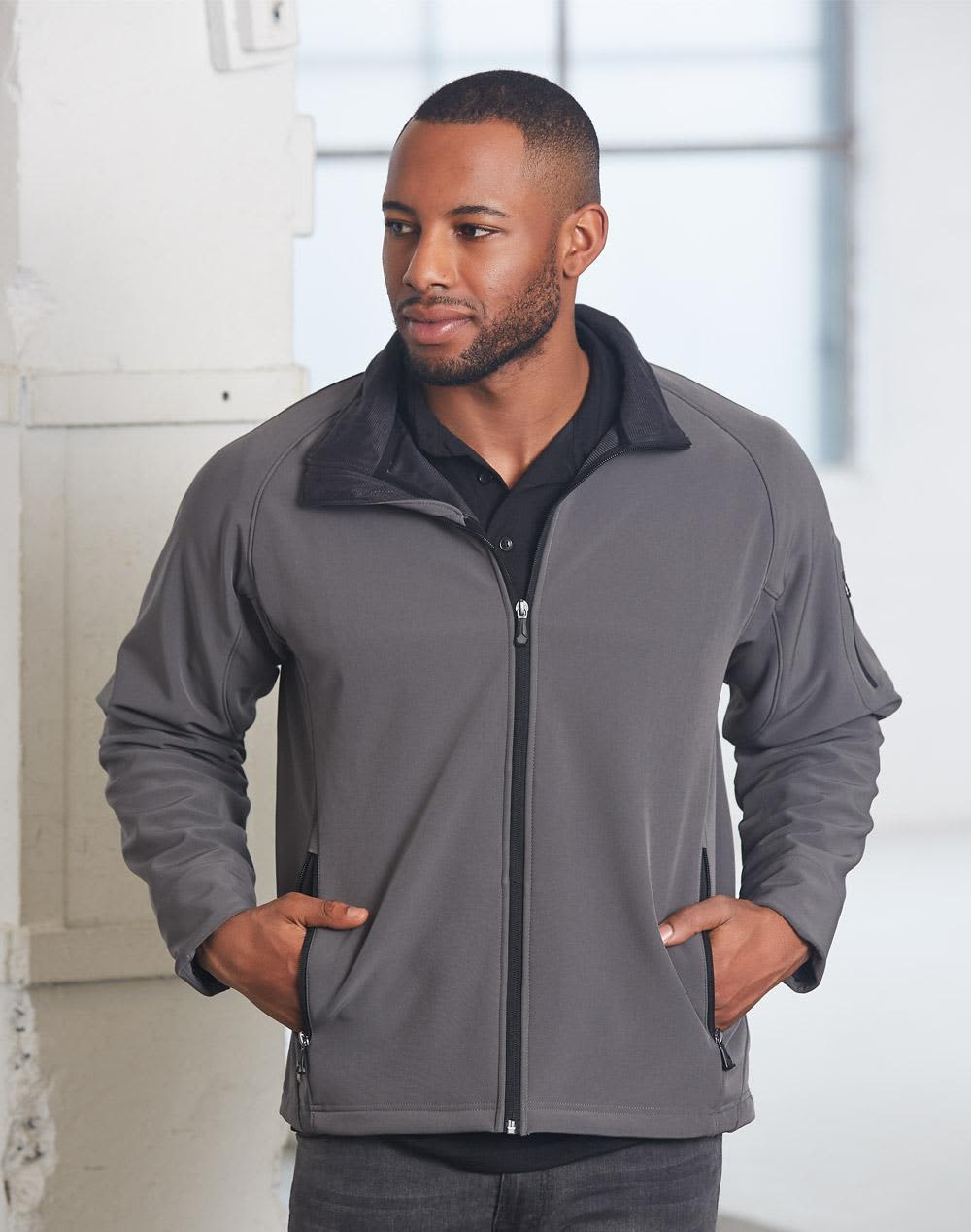 A men's softshell jacket in grey, featuring a zip-up front and side pockets, with a collar and branding. Men's Softshell High-Tech Jacket - Image 1