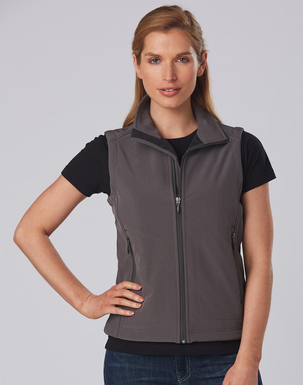 A grey ladies' softshell vest with a zip front and side pockets, worn over a black t-shirt. Features a logo. Ladies' Softshell Hi-Tech Vest - Image 1