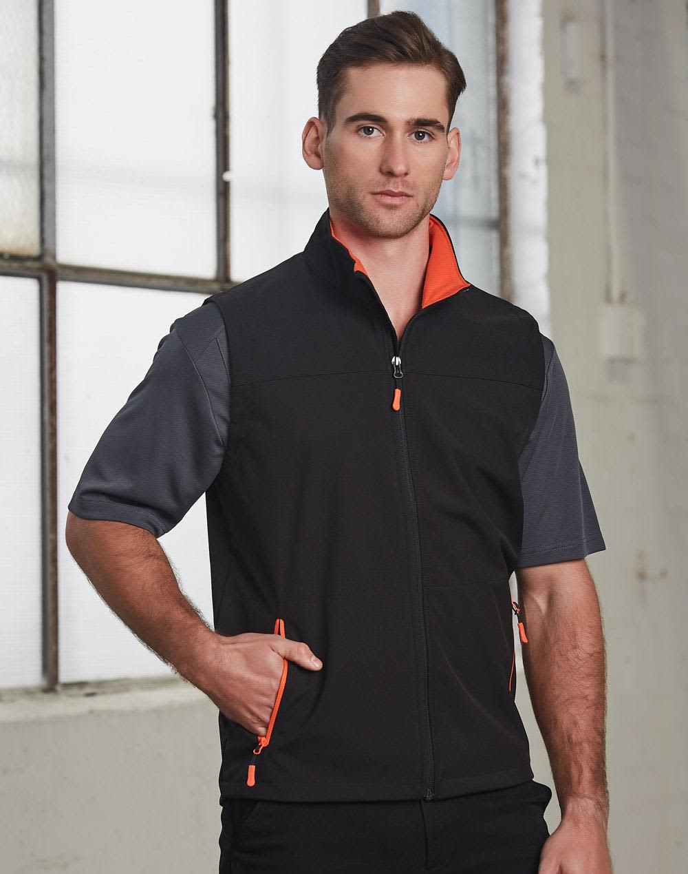 A men's softshell vest in black with orange accents, featuring a zip front and side pockets. It has a logo on it. Men's Softshell Contrast Vest - Image 1