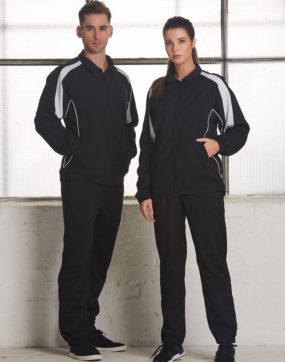A black track jacket featuring white accents, displayed on a male and female model. The jacket has a logo. Adults Warm Up Jacket - Image 1