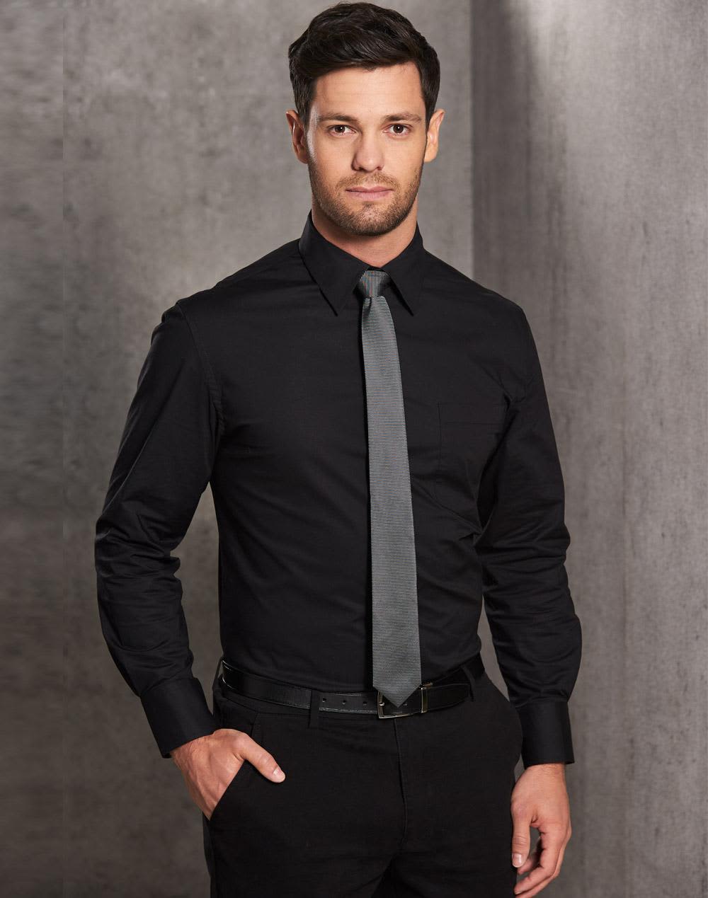 A man wears a black long-sleeve cotton/poly blend button-up shirt with a grey tie, featuring a chest pocket. Men's Cotton/Poly Stretch L/S Shirt - Image 1