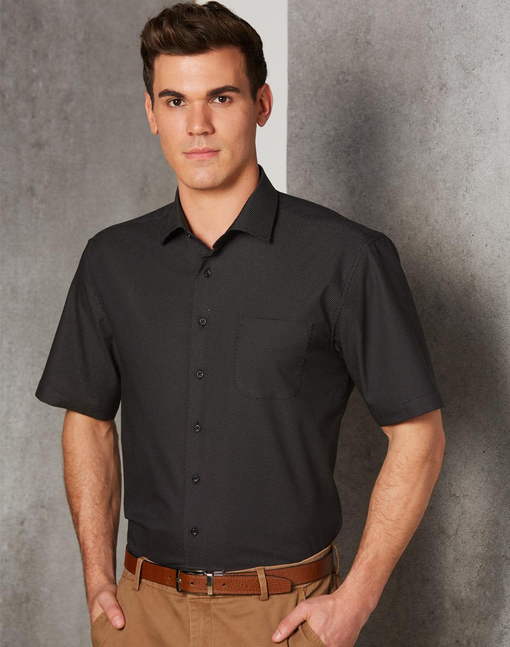 Men's short-sleeve button-up shirt in black with a pin dot pattern and a chest pocket. Features a logo. Men's Pin Dot Stretch S/S Shirt - Image 1