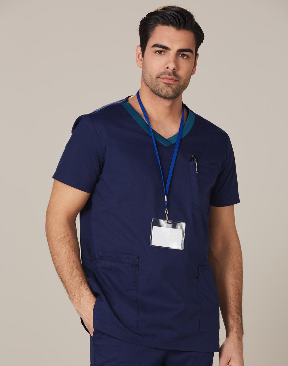 A men's short-sleeve scrub top in navy with contrast colour detail and a chest pocket, featuring a logo and ID badge. Men's Contrast Colour S/S Scrub Top - Image 1
