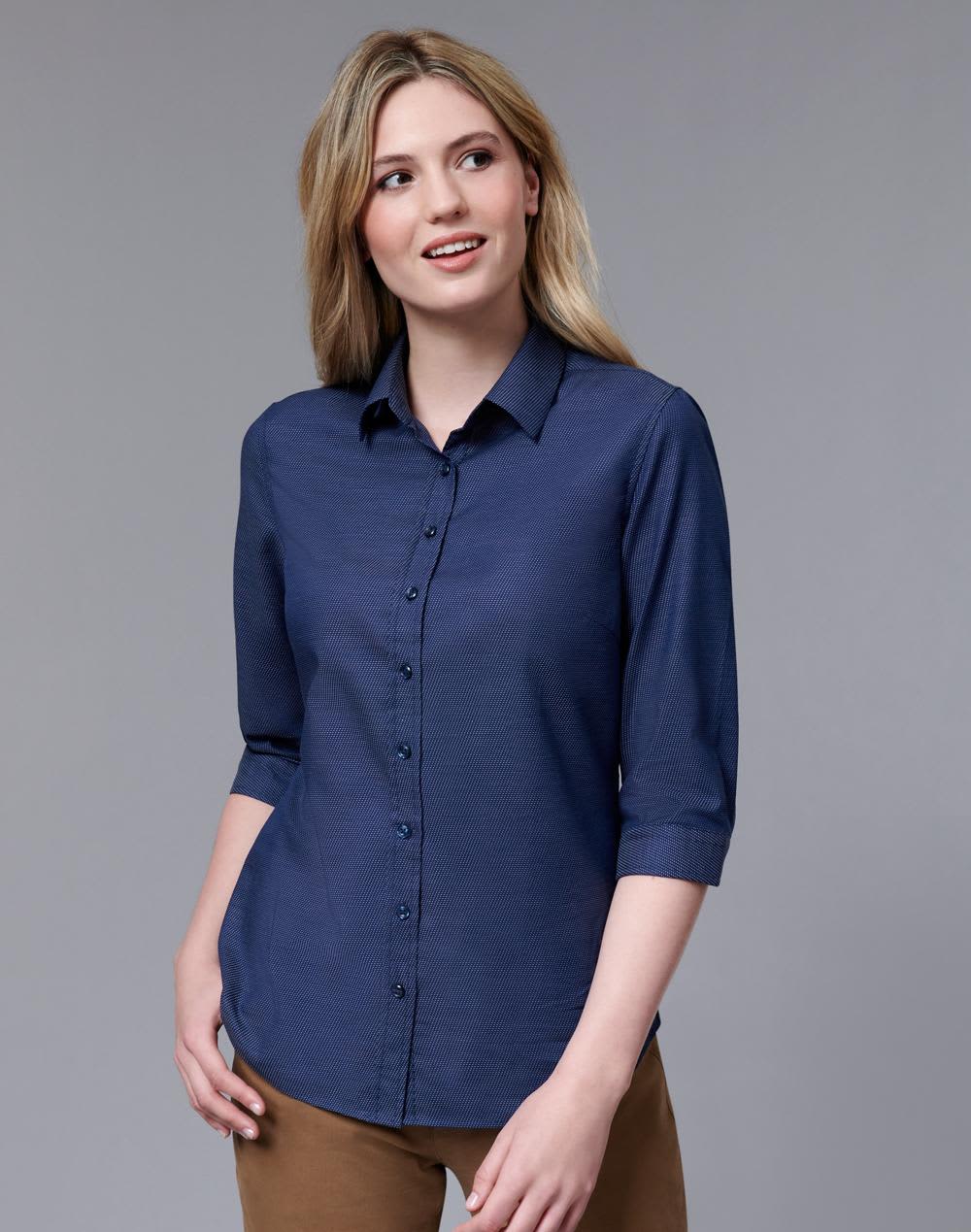 A navy button-up shirt with a pin dot pattern and 3/4 sleeves, featuring a collar and branded logo. Ladies' Pin Dot Stretch 3/4 Sleeve Shirt - Image 1