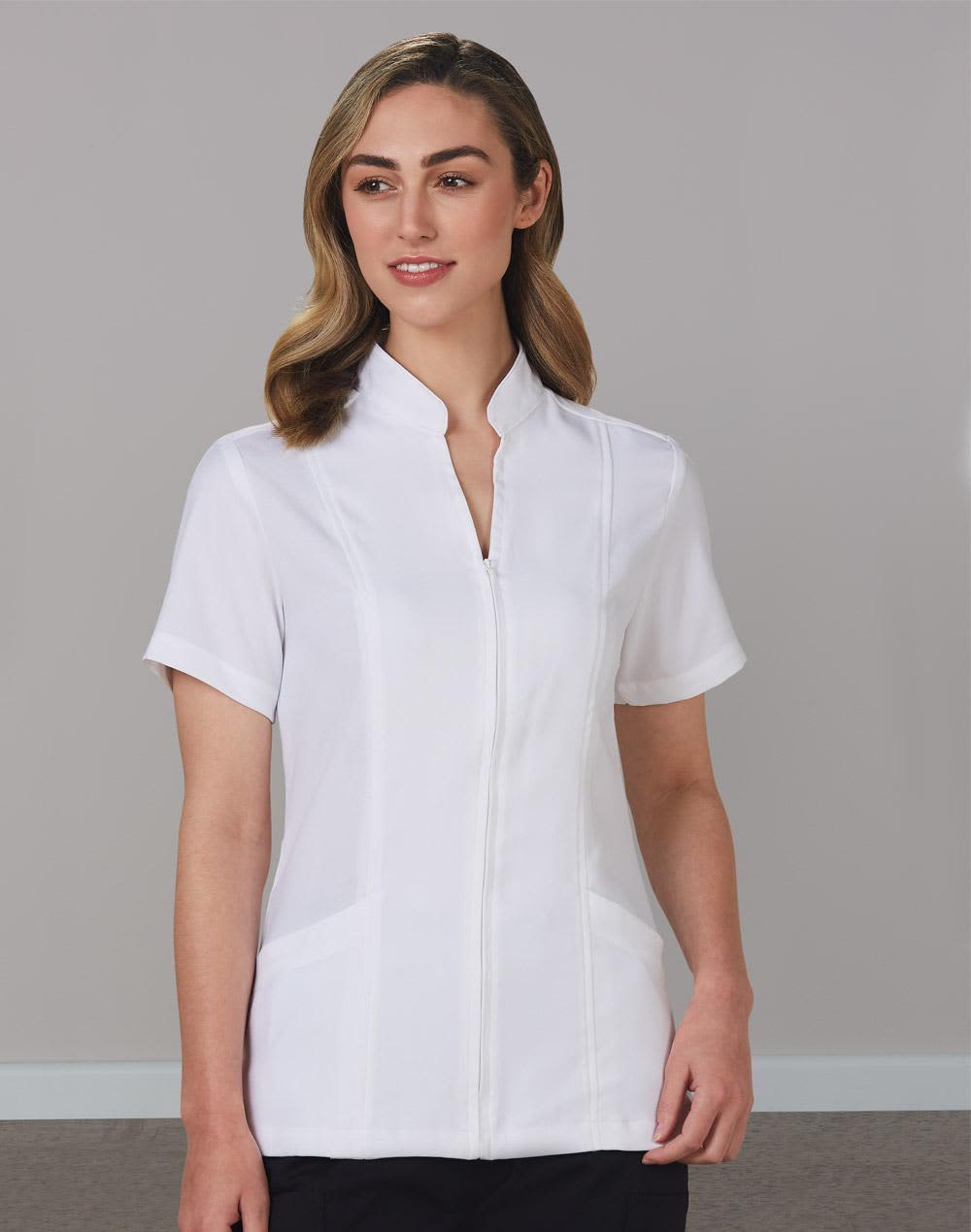 A white women's full zip front tunic with short sleeves and a stand-up collar, featuring a logo. Women's Full Zip Front Short Sleeve Tunic - Image 1