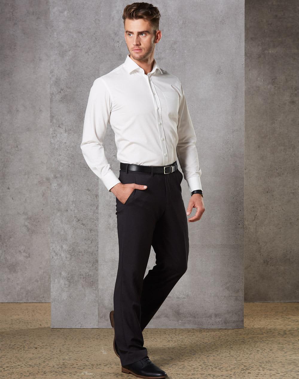 A man wearing black stretch wool blend pants paired with a white shirt and black shoes, standing in a modern setting. Men's Stretch Wool Blend Pants - Image 1