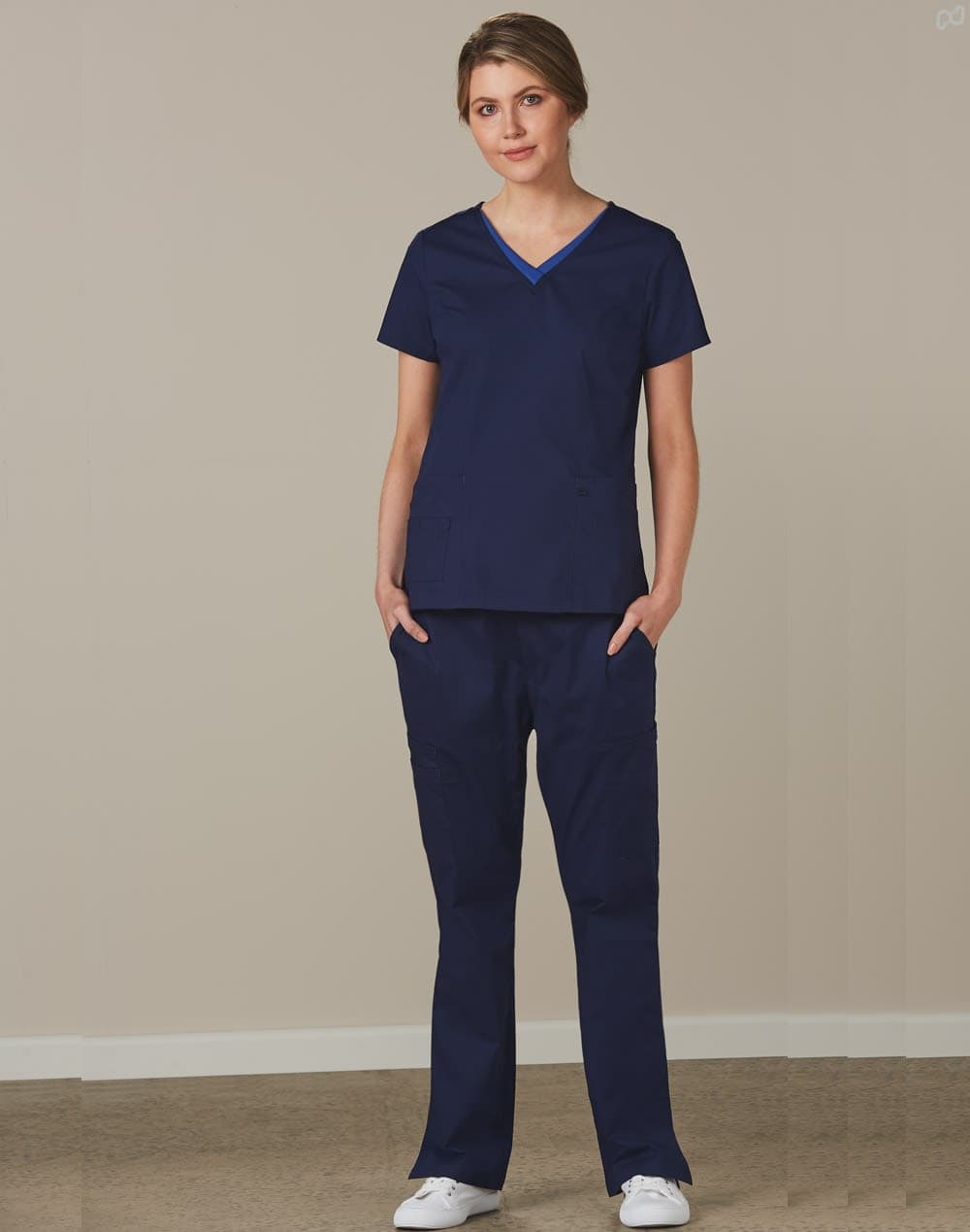 Navy solid colour scrub pants paired with a navy scrub top, featuring a simple design and pockets. Ladies' Solid Colour Scrub Pants - Image 1