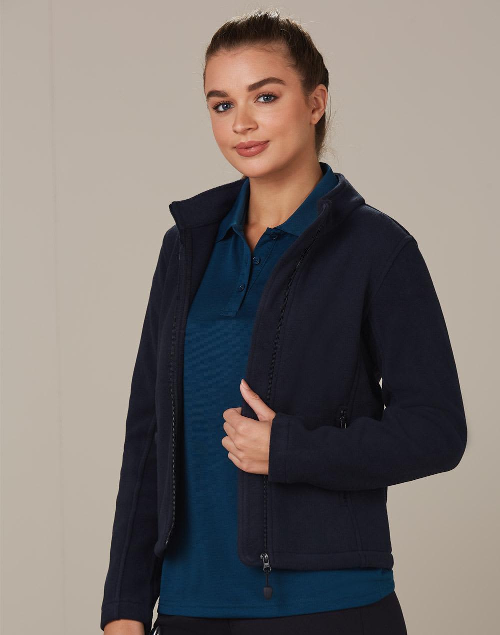 A navy polar fleece jacket with a zip front and high collar, worn over a blue polo shirt. It features a logo. ladies bonded P/F full zip jacket - Image 1