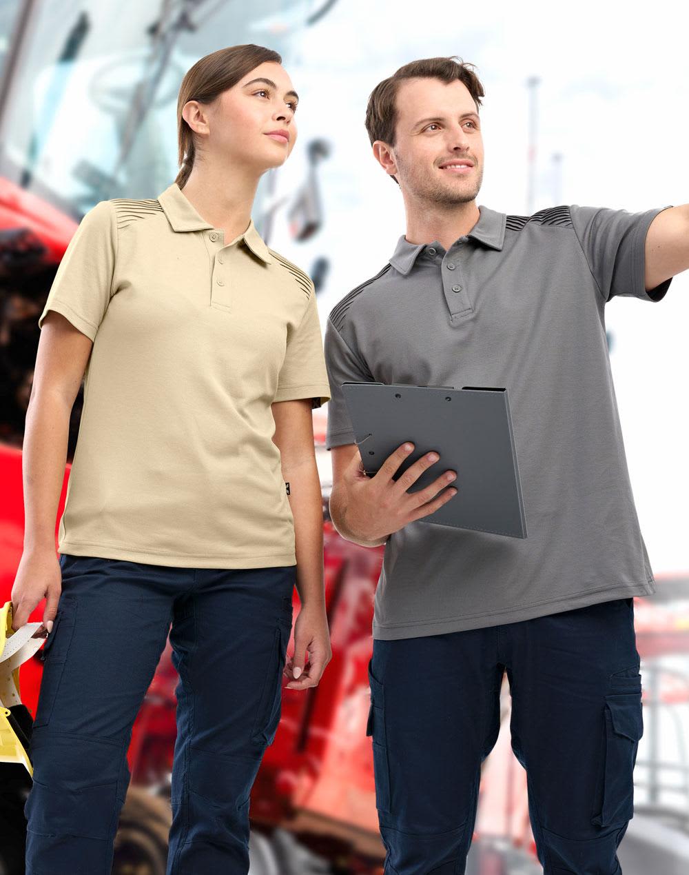 A navy blue polo shirt features textured shoulder detailing and is worn by a man with a cap. The shirt has a logo. AIWX Workwear S/S Polo - Image 1