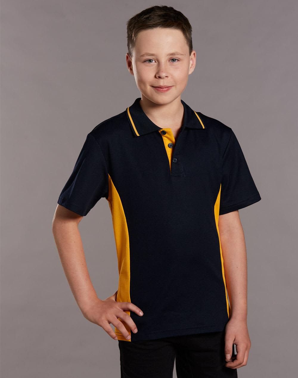 A young boy models a navy and gold contrast polo shirt, featuring a classic collar and a logo. Kids' TrueDry Contrast S/S Polo - Image 1