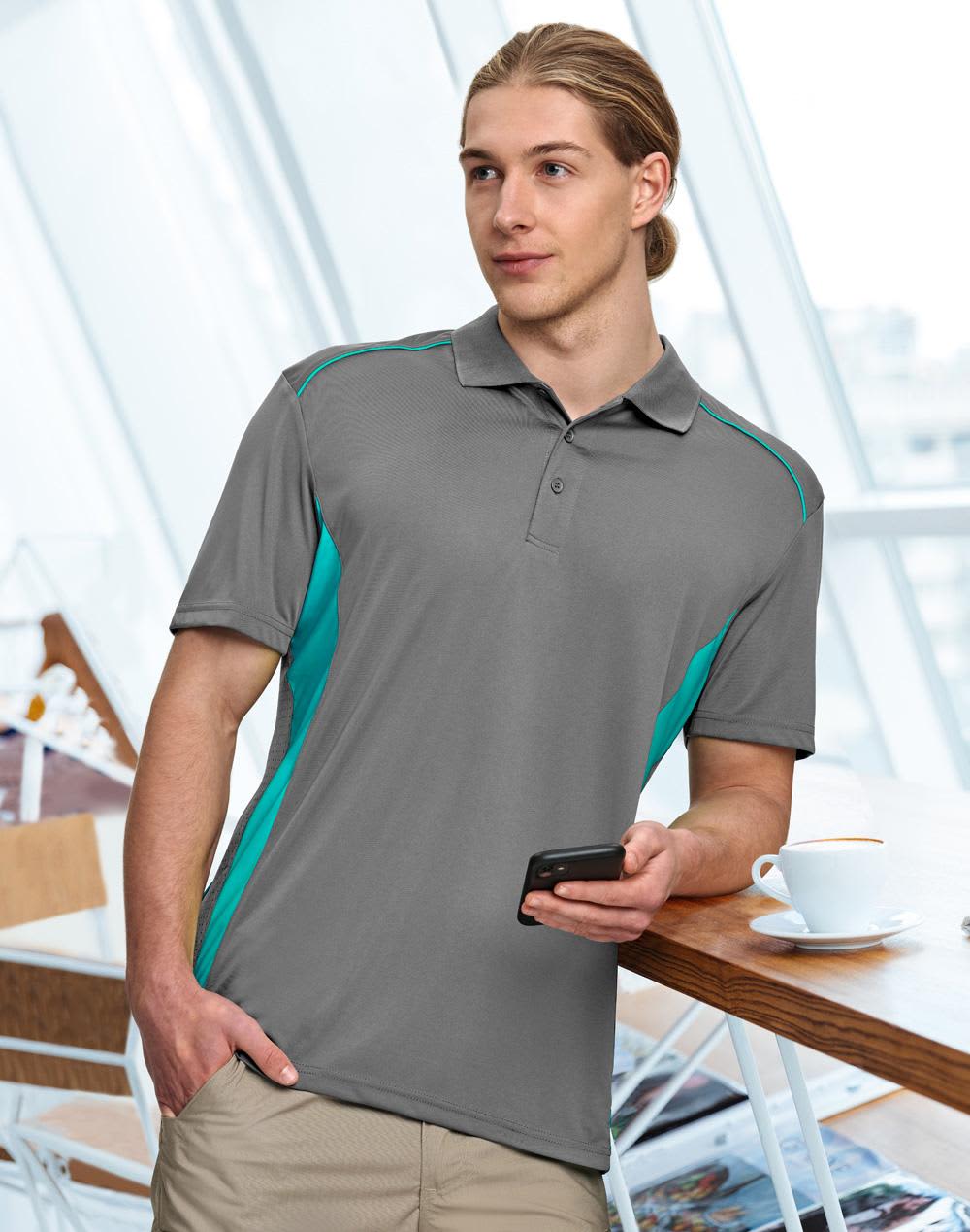 A dark green polo shirt with bright green accents and a logo, worn by a man standing indoors. Men's Cooldry S/S Contrast Interlock Polo - Image 1