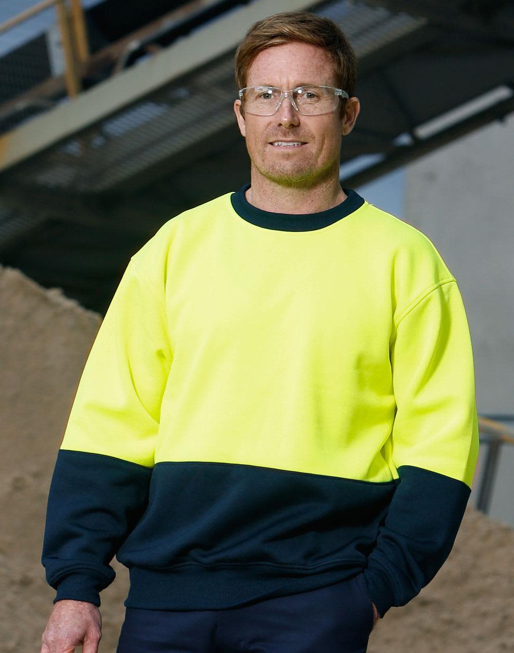 A Hi-Vis two tone safety windcheater in bright yellow and navy, worn by a man with safety glasses. Hi-Vis two tone safety windcheater - Image 1
