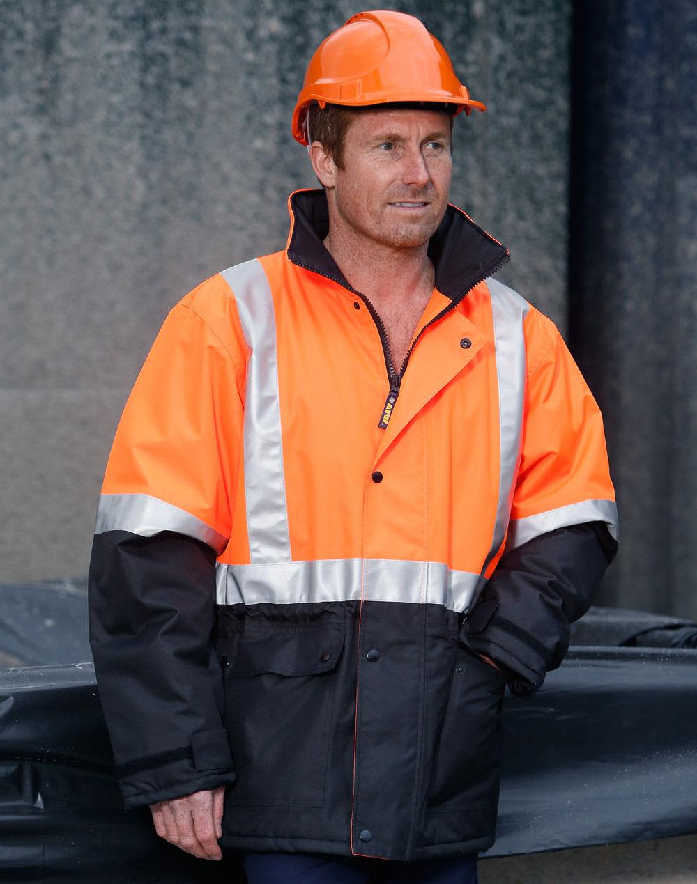 A hi-vis orange and black quilted safety jacket with reflective strips, worn by a person in an orange hard hat. Hi-Vis Two Tone Rain Proof Quilted Safety Jacket With 3M Tapes - Image 1