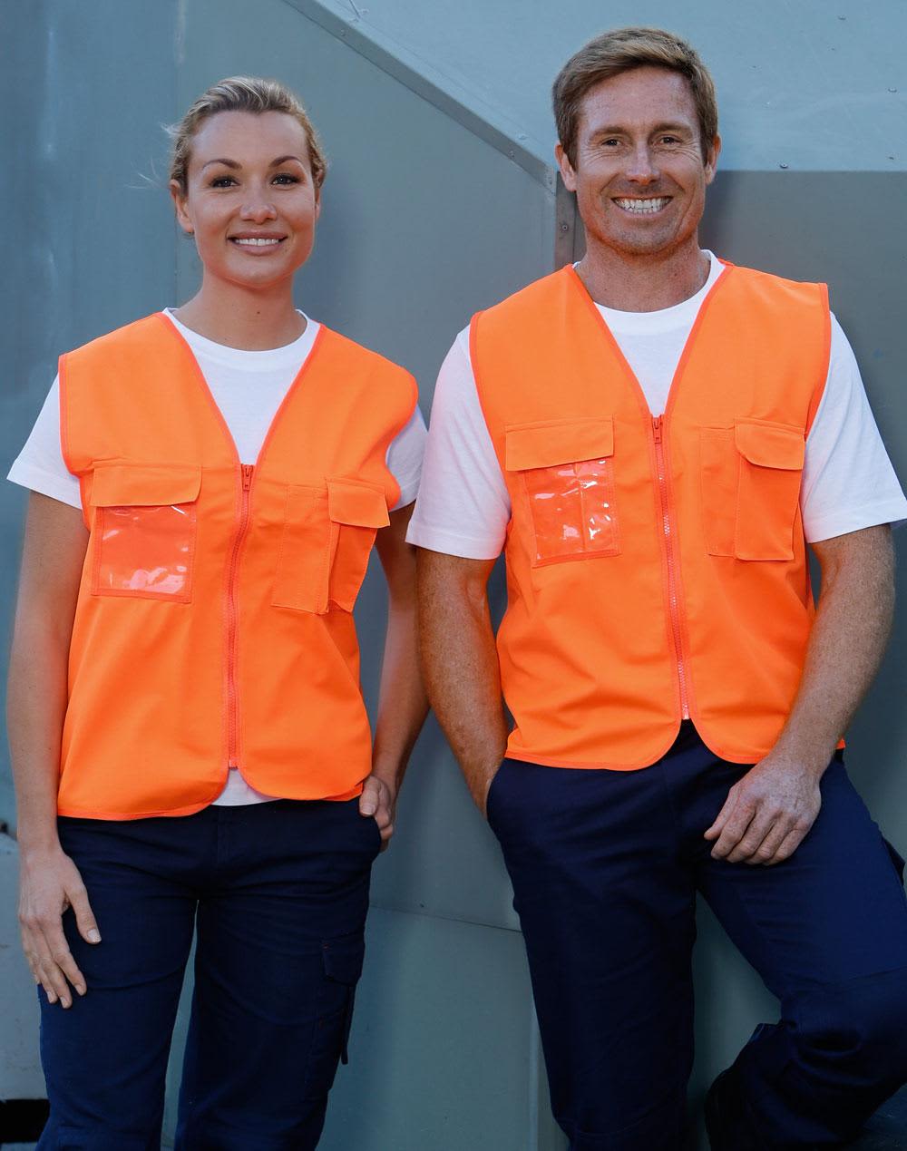 Hi-Vis safety vests in fluorescent orange with ID pockets, worn by two smiling individuals against a grey background. Hi-Vis Safety Vest with ID Pocket - Image 1