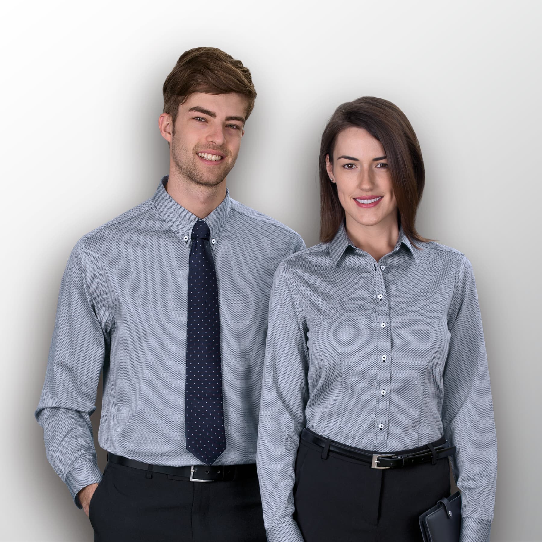 A men's button-up shirt in a grey check pattern, modelled by a man and a woman wearing formal attire. The Bretton Shirt - Mens - Image 1