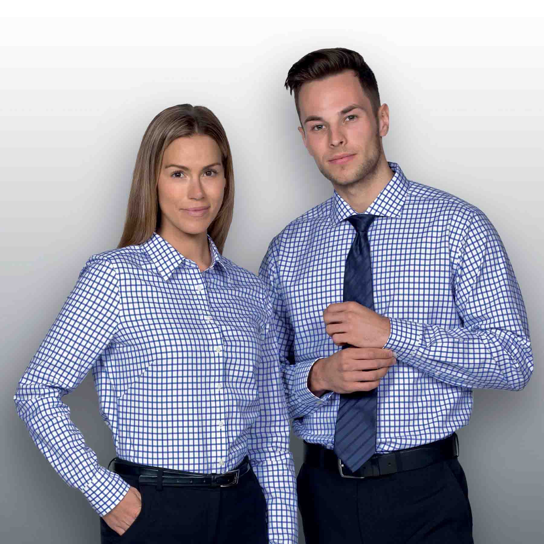 A button-up shirt featuring a blue and white check pattern, displayed on a male and female model, both with a logo. The Identity Check Shirt - Mens - Image 1
