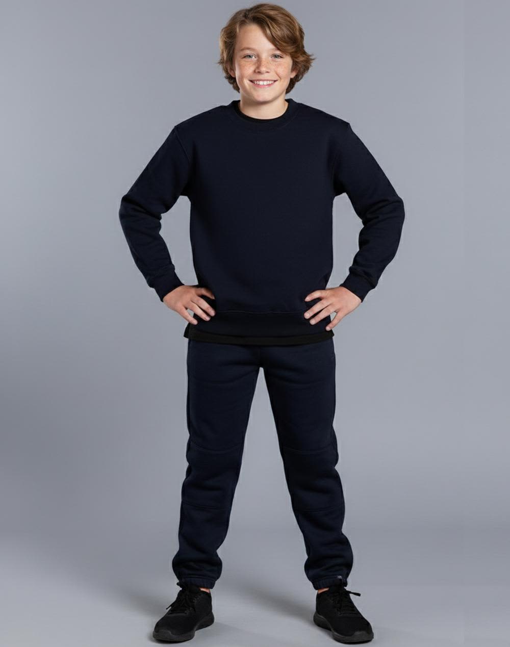Kid's black fleecy trackpants with zip, cuffs, knee padding, and pockets, featuring a logo. Kid's fleecy trackpants with Zip, Cuffs and knee padding - Image 1