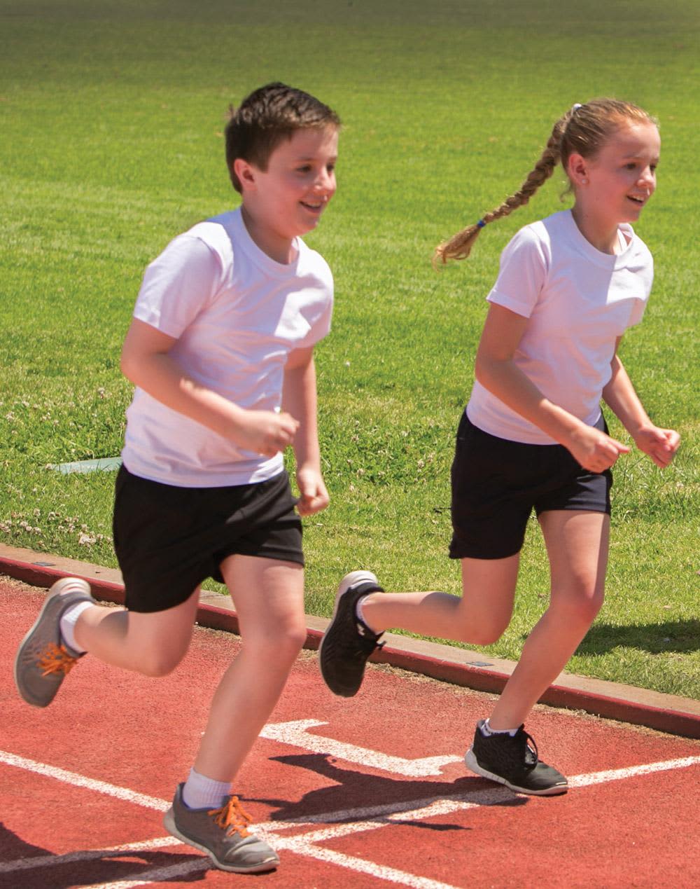 Two children running on a track, wearing white T-shirts and black shorts. Kids tee - Image 1