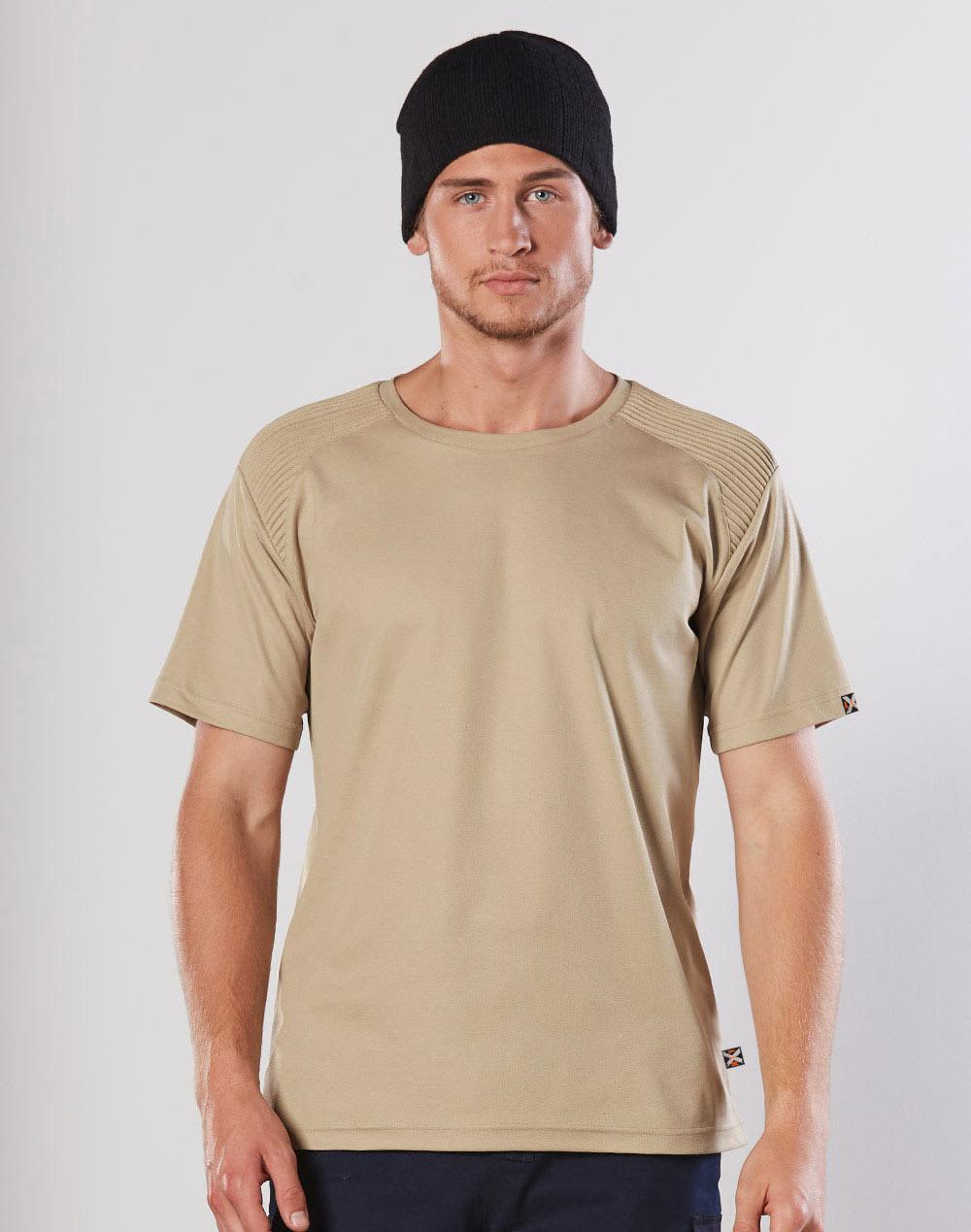A beige short-sleeve work t-shirt with a textured shoulder design, worn by a model in a black beanie. AIWX Workwear S/S Tee - Image 1