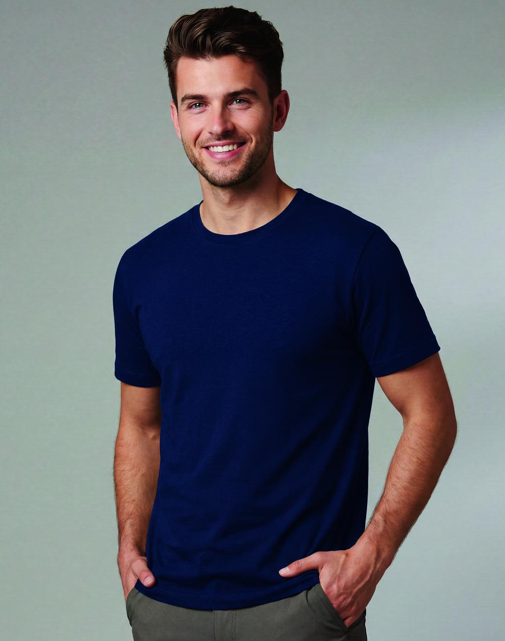 Men's premium cotton short sleeve T-shirt in a soft green shade, featuring a logo, worn by a man on a sailboat. Men's Premium Cotton Face S/S Tee Shirt - Image 1