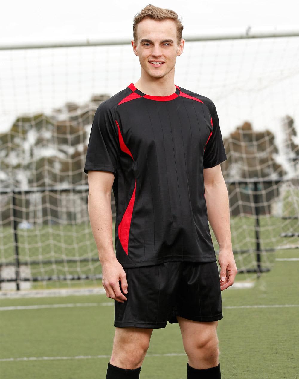 A black adults' soccer jersey with red accents, featuring short sleeves and a sporty design, displayed on a model. Adults' Soccer Jersey - Image 1