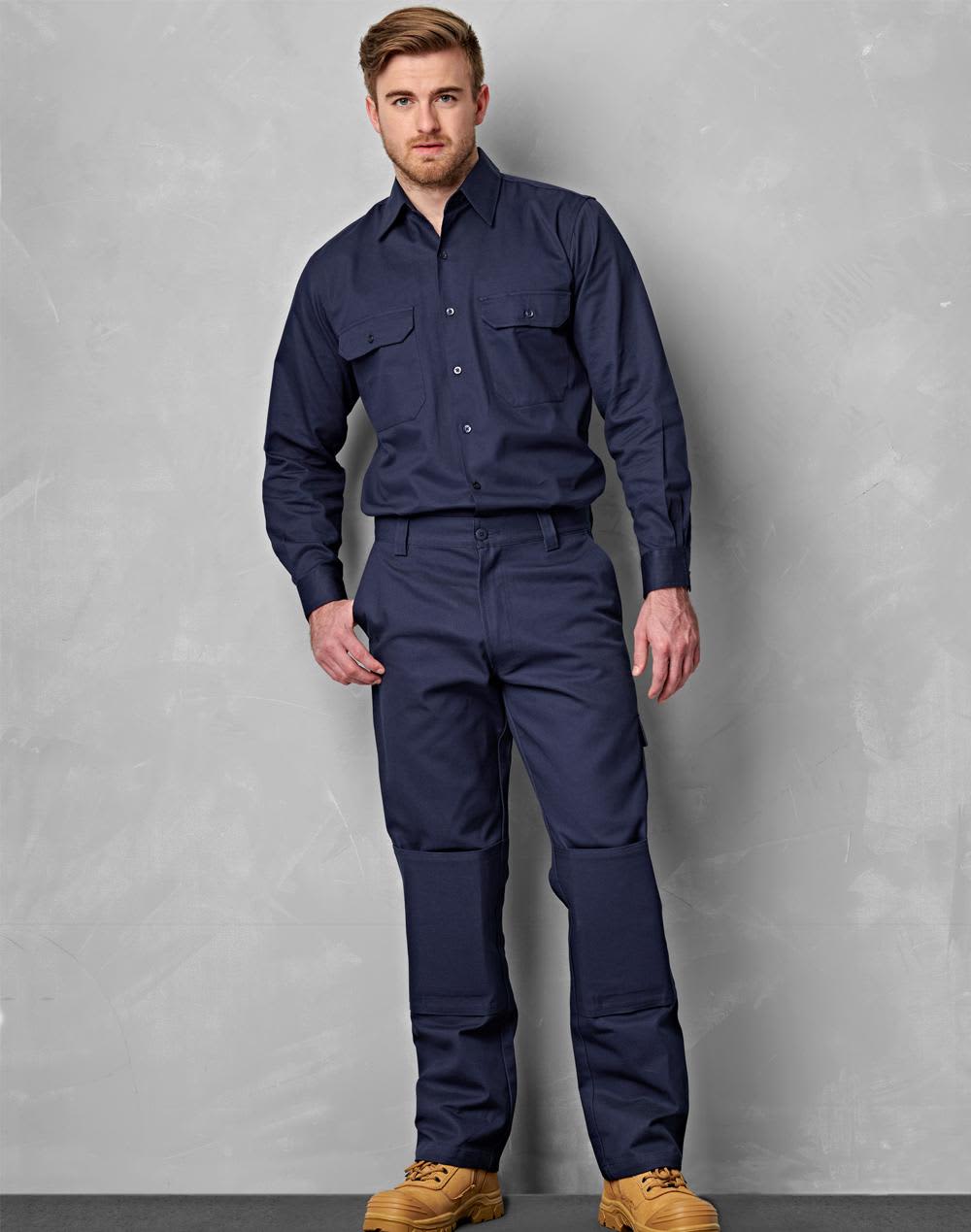 Navy blue men's cotton drill cargo pants featuring knee pads, with a fitted design and button-up shirt. Men's Cotton Drill Pre-shrunk Cargo Pants With Knee Pads - Image 1