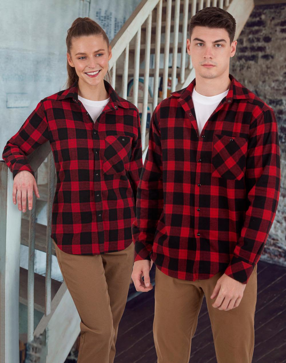 A unisex flannel plaid shirt in red and black, displayed on a male and female model, featuring a logo. Unisex Flannel Plaid Shirt - Image 1