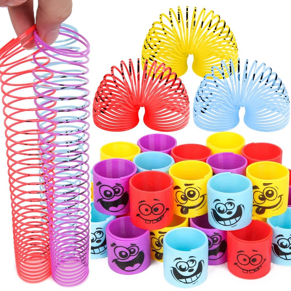 A collection of colourful coil spring toys, including pink, red, yellow, and blue, featuring smiling cartoon faces. Coil Spring Toy - Image 1