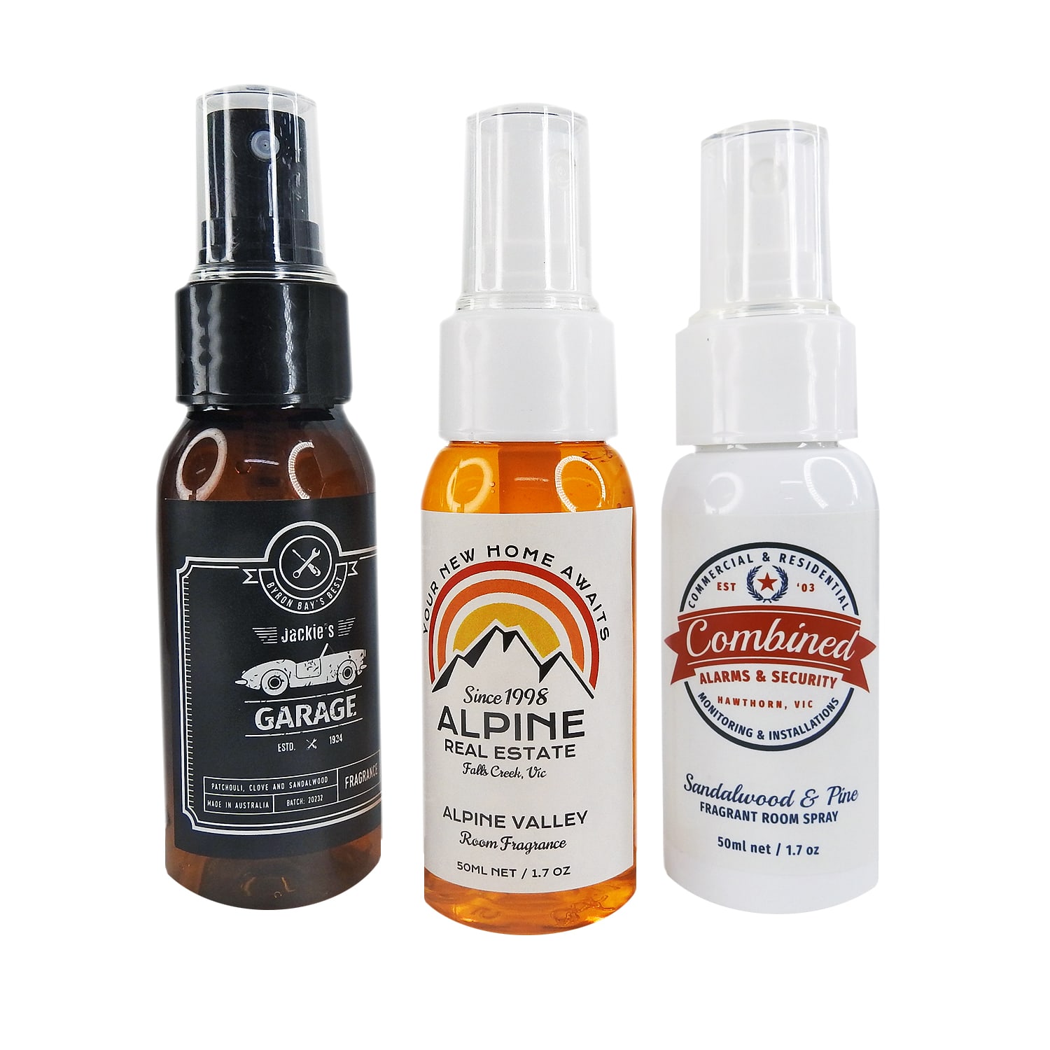 A selection of three room fragrance bottles in black, amber, and white, featuring different designs and a logo on each. Room Fragrance Bottle - Image 1
