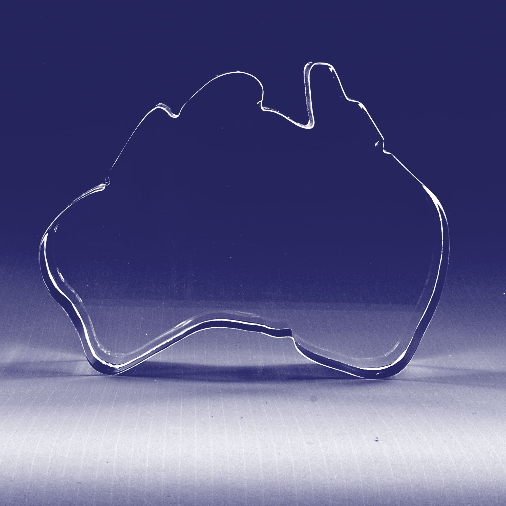 A crystal clear 3D shape of Australia, outlined with smooth edges, showcasing its distinctive map outline. 3D Crystal Australia Shape (150mm wide) - Image 1