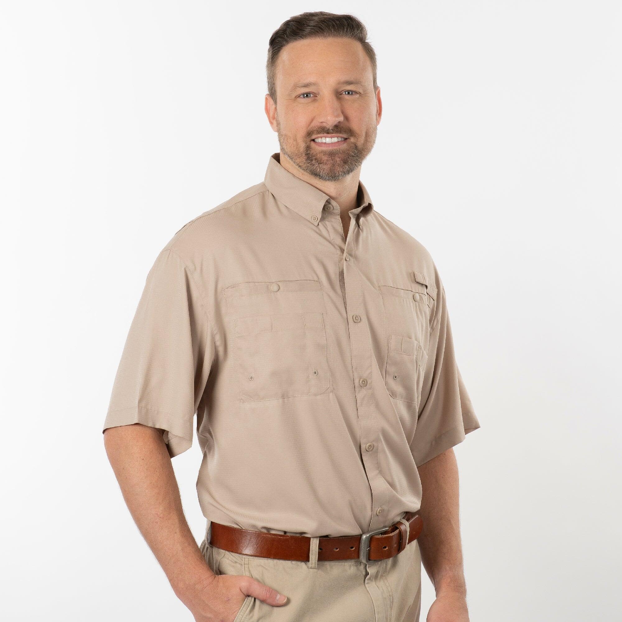 A short-sleeved black fishing shirt with a button-up front and two chest pockets, featuring a branding logo. Short Sleeve Fishing Shirt - Image 1