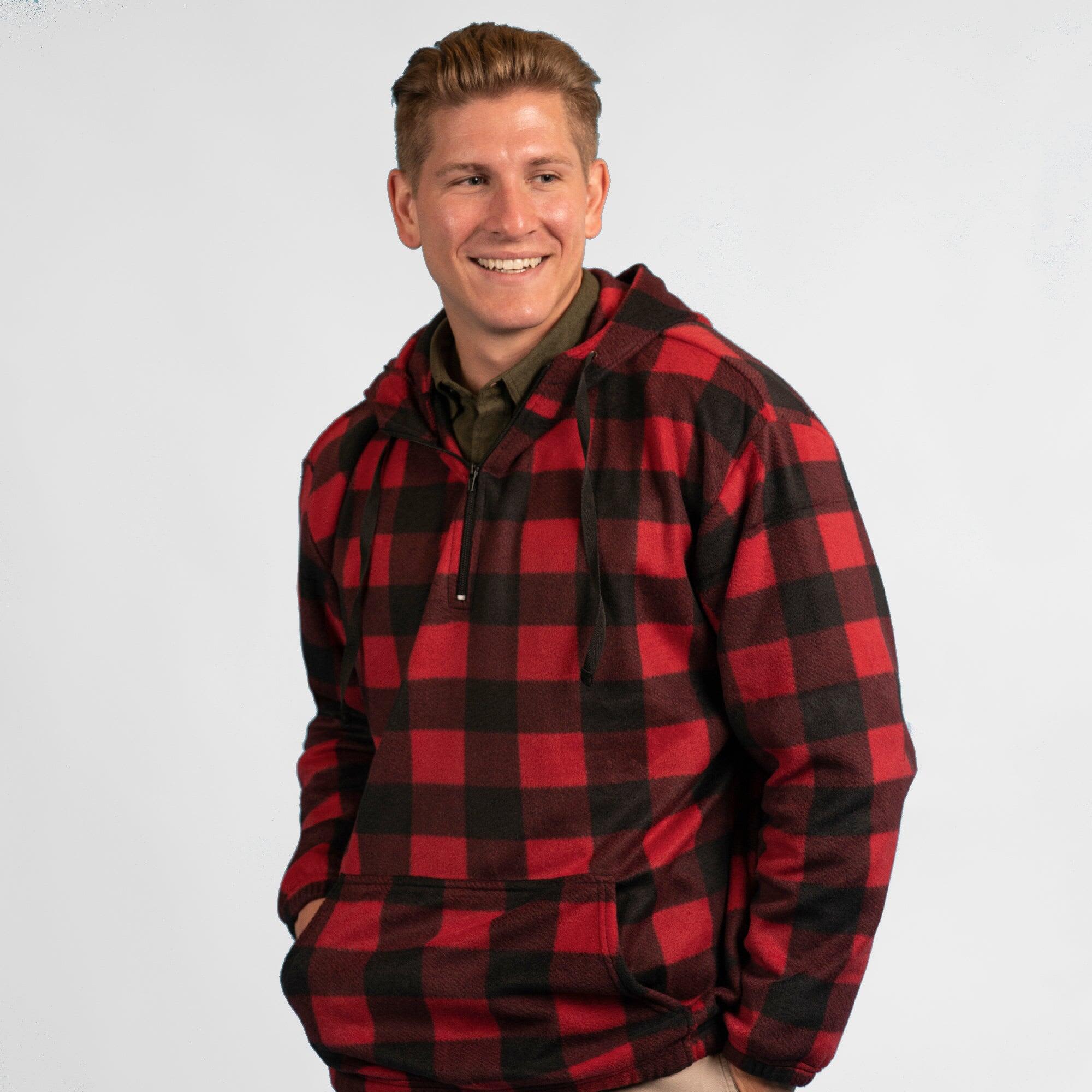 A red and black checkered 1/4 zip polar fleece hoodie worn by a smiling man. Features a front pocket and a logo. 1/4 Zip Polar Fleece Hoodie - Image 1