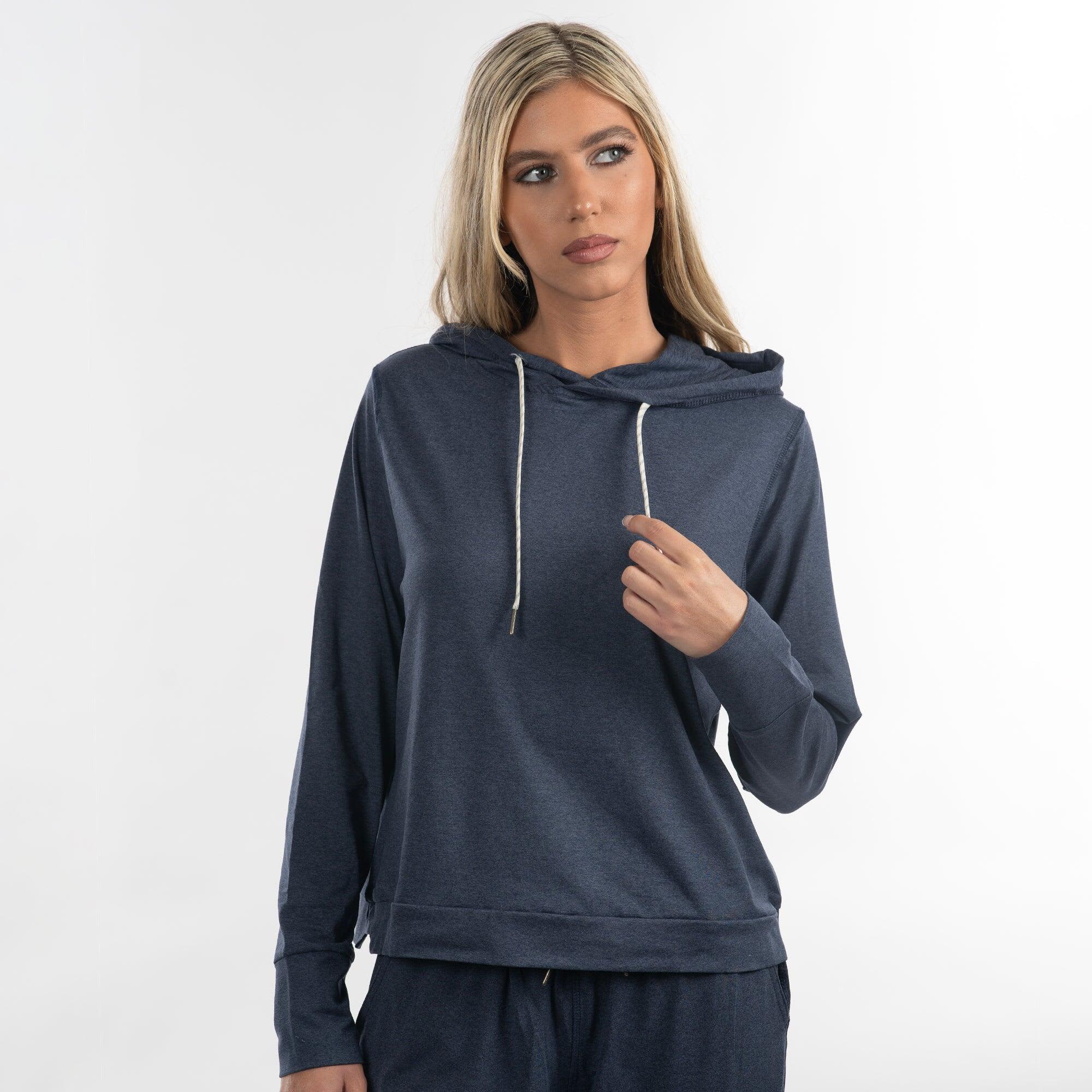 A modest crop hoodie in navy blue, featuring a loose fit and drawstring hood. The model stands against a plain background. Modest Crop Hoodie - Image 1