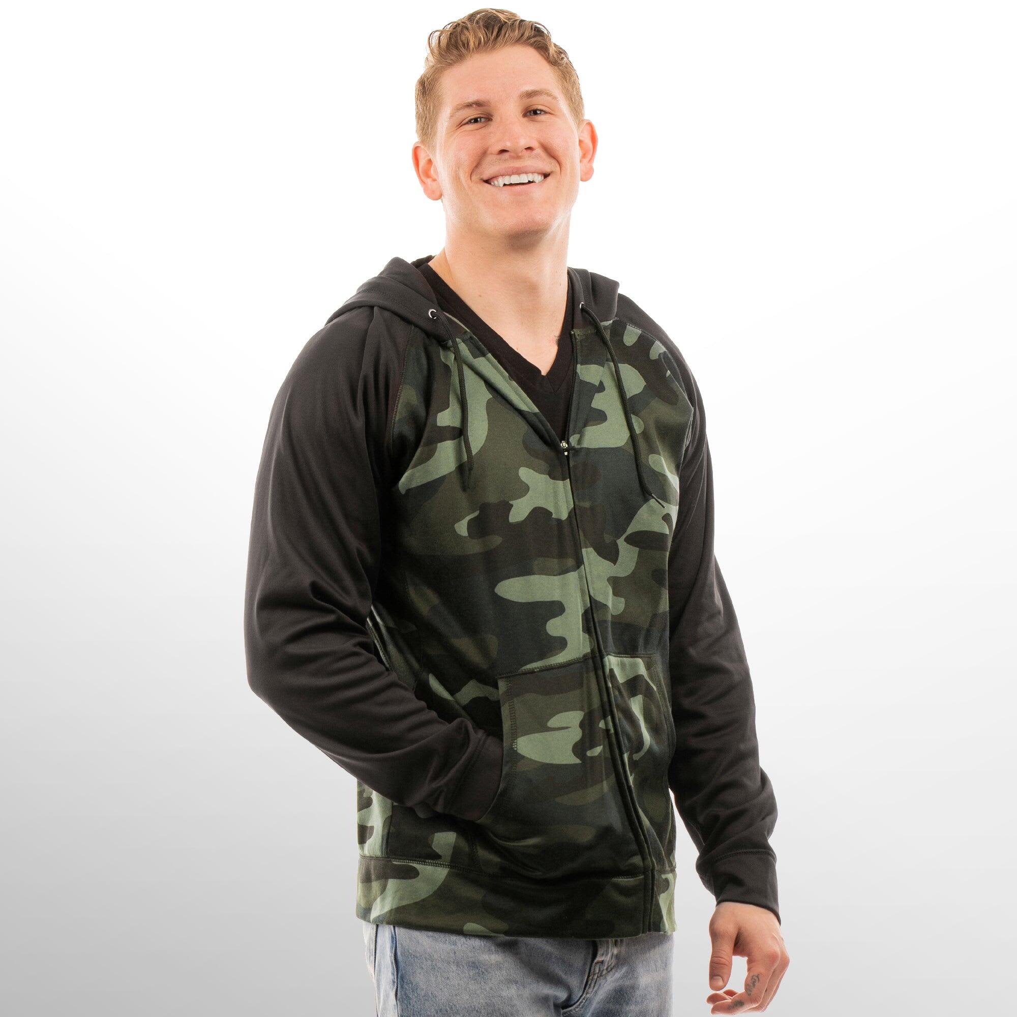 A camouflage and black Full Zip Performance Raglan Hoodie on a smiling model, featuring a hood and zip closure. Full Zip Performance Raglan Hoodie - Image 1