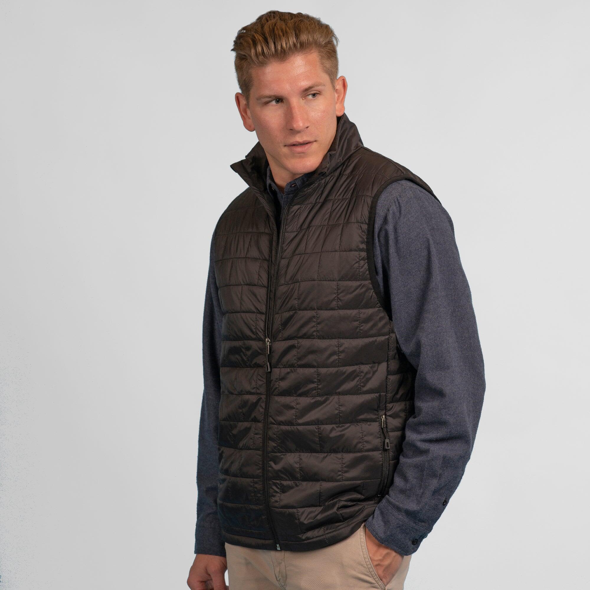 A quilted puffer vest in black, featuring a zip front and a simple design with a logo. Quilted Puffer Vest - Image 1