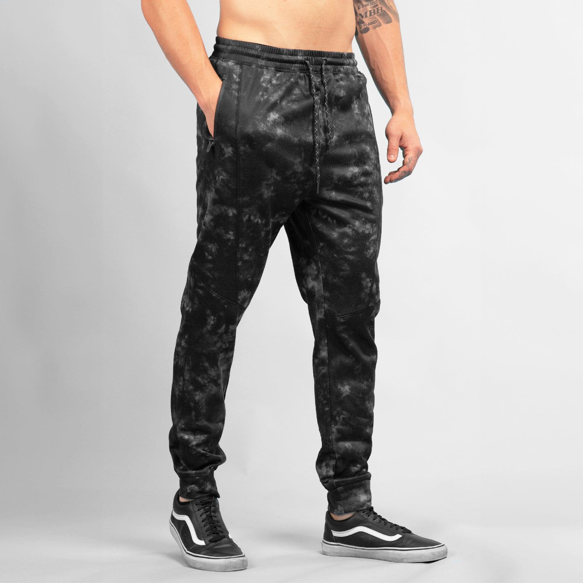 Black Tech Fleece Knit Jogger Pants with a textured design and side pockets, featuring a logo. Tech Fleece Knit Jogger Pants - Image 1