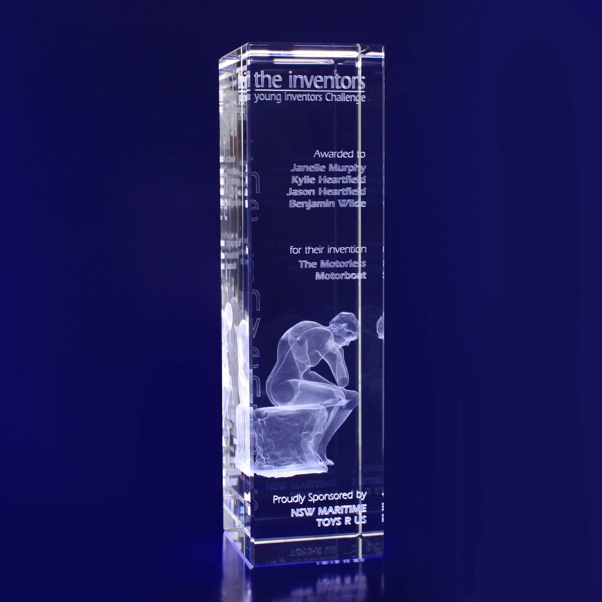 A crystal rectangle trophy featuring a carved figure in contemplation, showcasing a logo and award details. Clear and luminous. 3D Crystal Rectangle Bar - Image 1