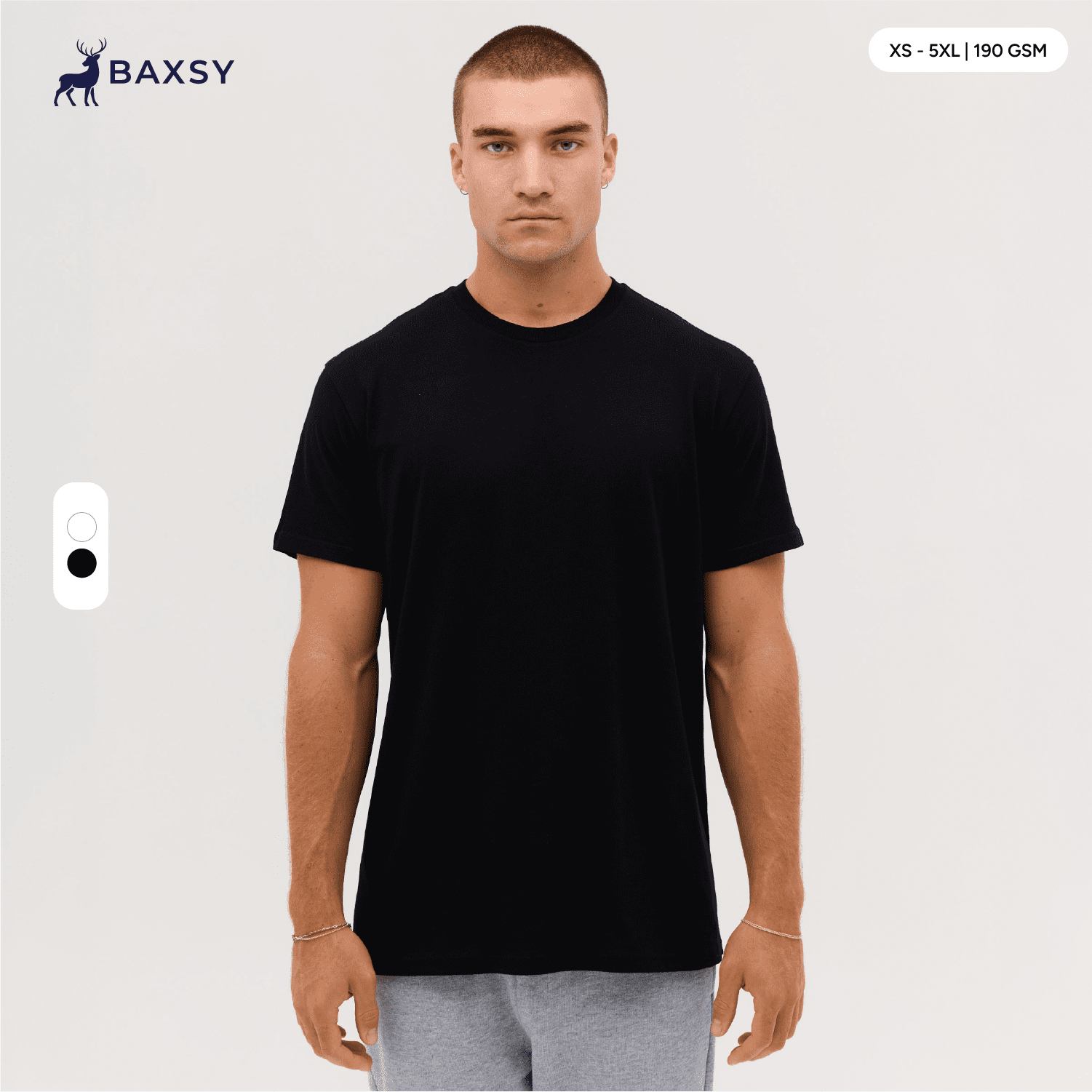A black t-shirt is displayed on a model, featuring a round neck and short sleeves, with a logo visible. Everyday Tee - Image 1