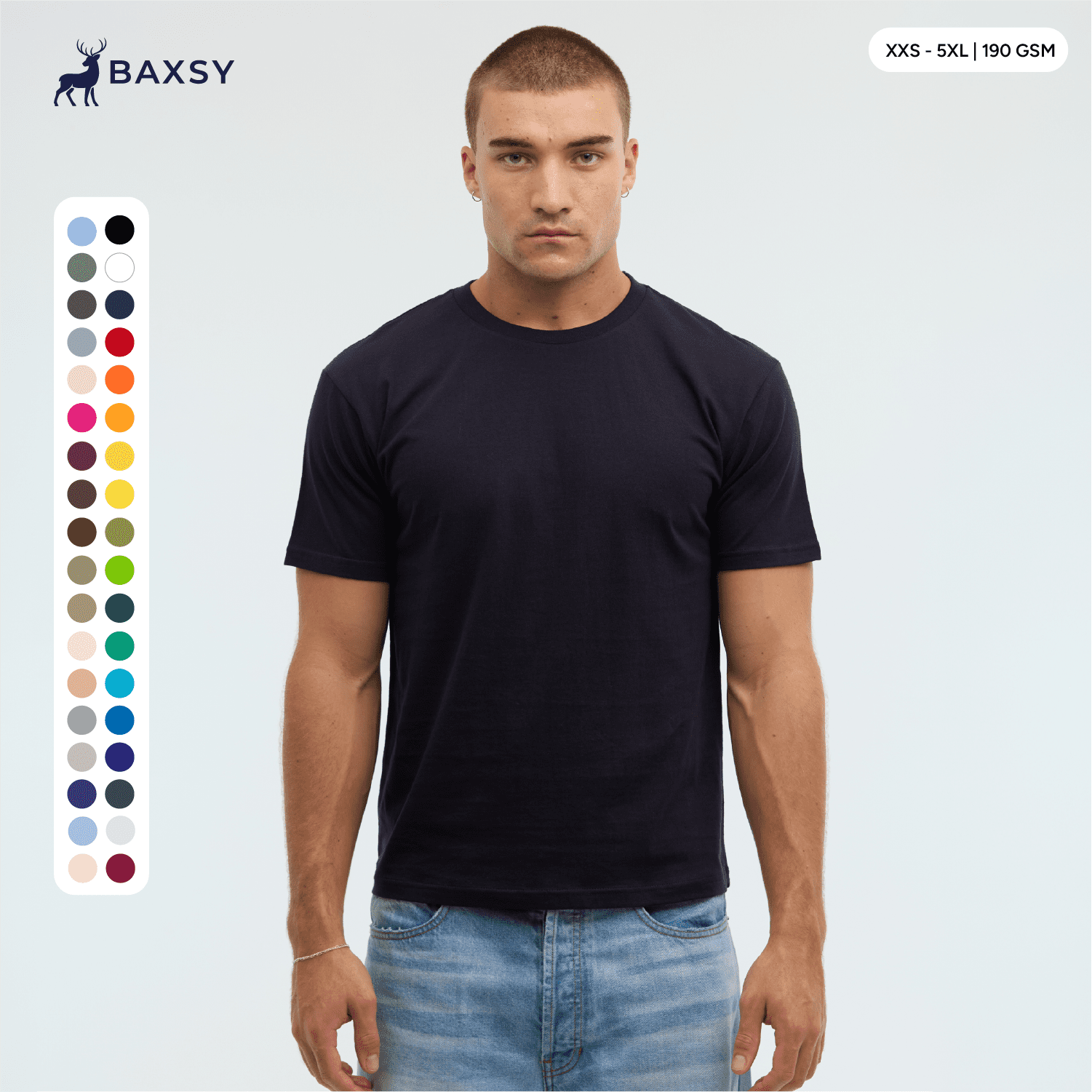A model wears a navy blue Essential/Surf Tee, featuring a range of colour swatches on the side and a logo at the top. Essential/Surf Tee - Image 1
