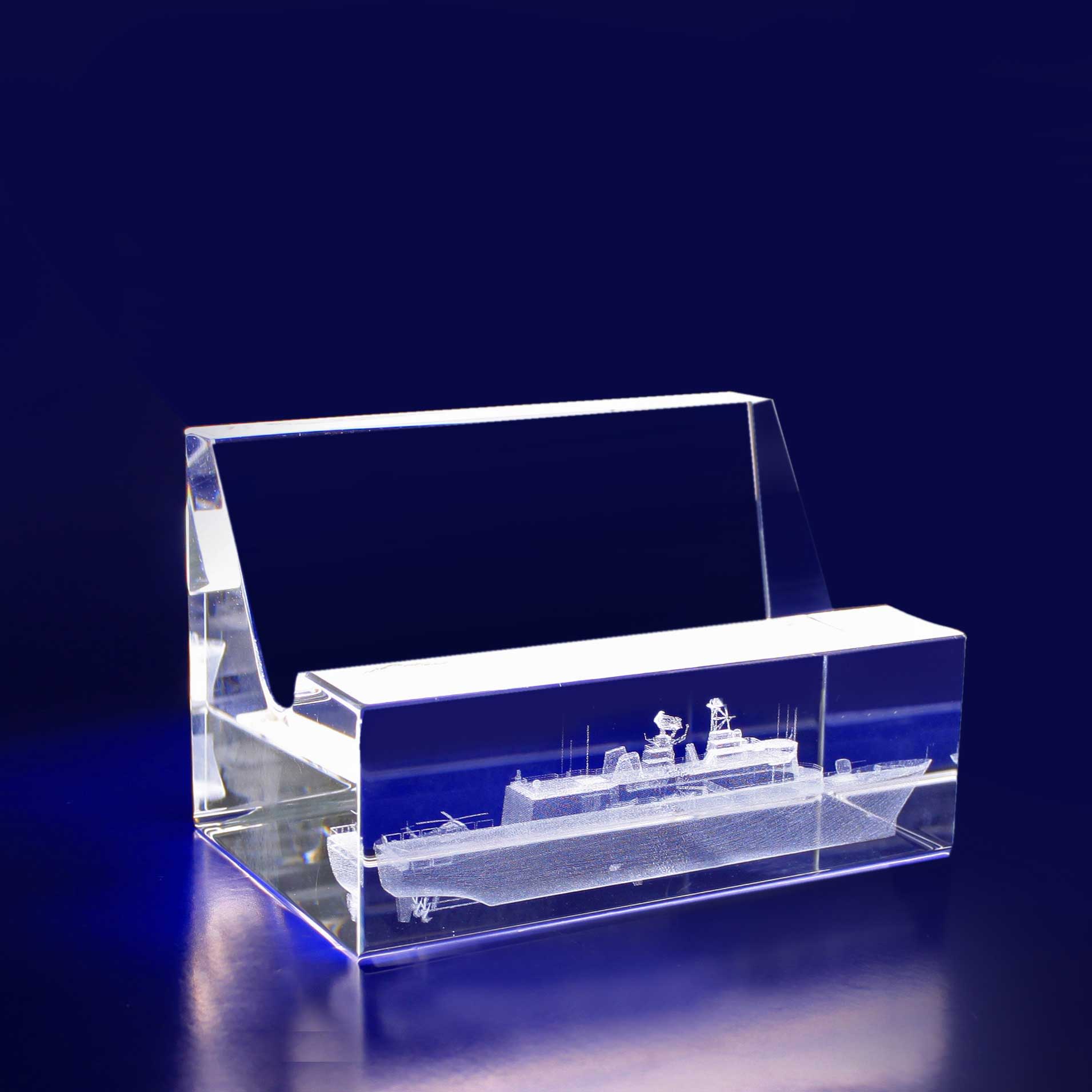 A 3D crystal business card holder in clear acrylic, featuring an intricate design of a ship inside. 3D Crystal Business Card Holder - Image 1