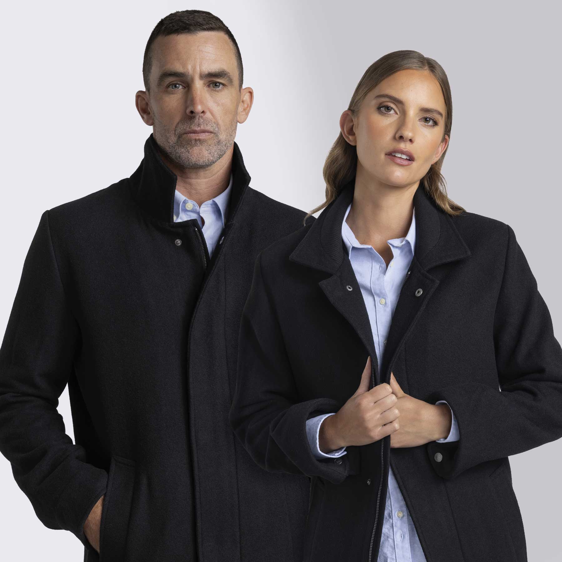 A black wool jacket featuring a collar, worn by a man and a woman, both in smart casual attire. Barkers Corporate Carnaby Wool Jacket - Image 1