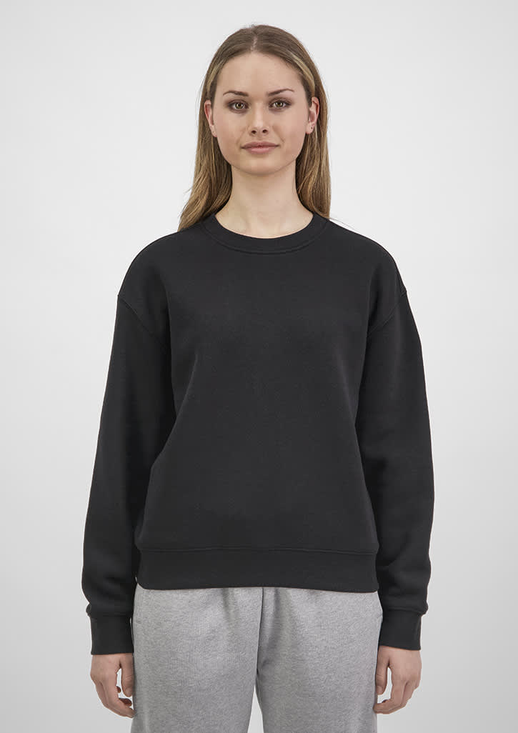 A black women's crew sweatshirt is displayed on a model, featuring a relaxed fit and long sleeves. Womens Everyday Crew Sweatshirt - Image 1