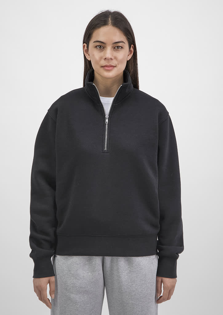 A black women's 1/4 zip sweatshirt featuring a high collar and long sleeves, displayed on a model. Womens Everyday 1/4 Zip - Image 1