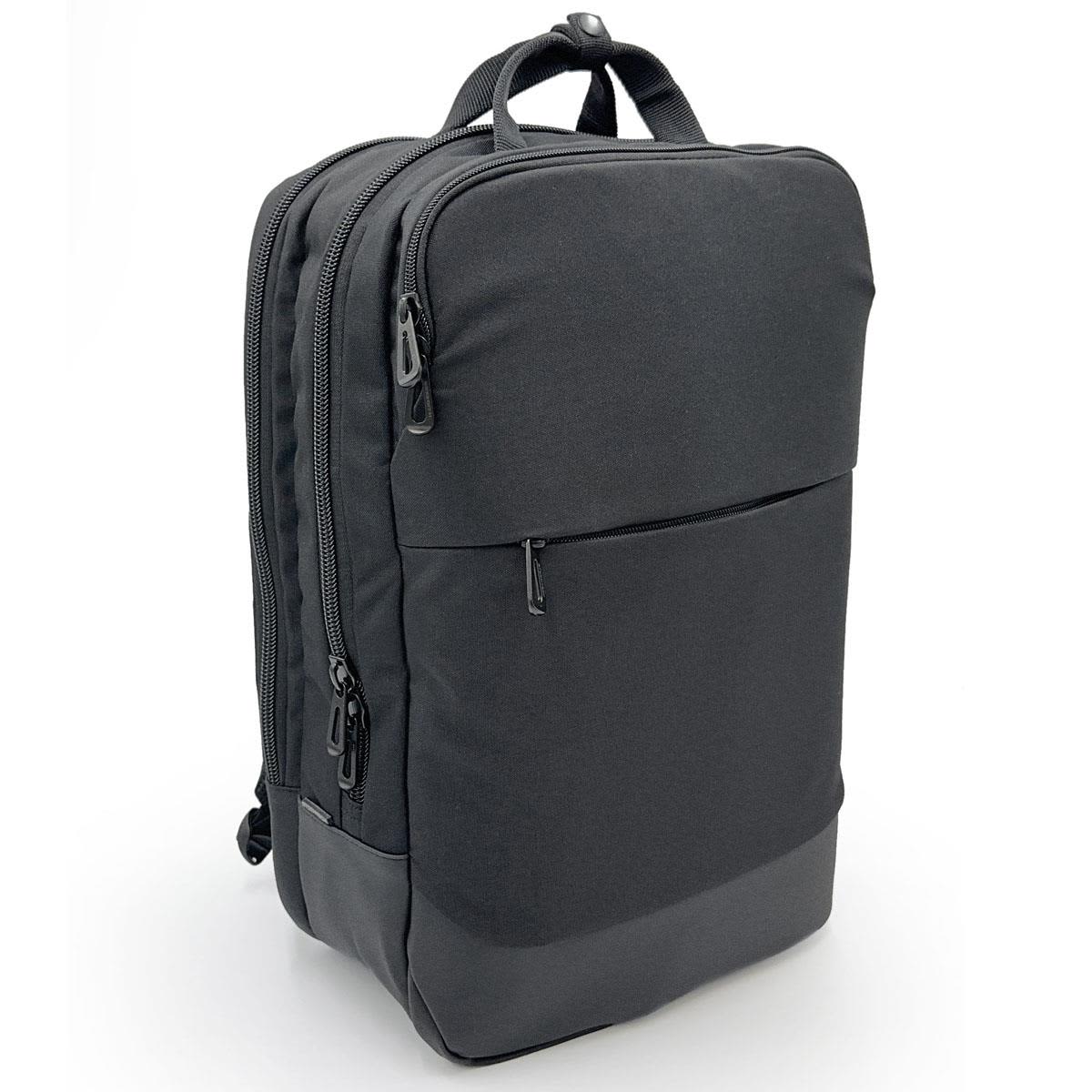 A sleek black laptop bag with multiple zippers and a front pocket, featuring a minimalist design and branding. Yaletown Commuter Pack - Image 1