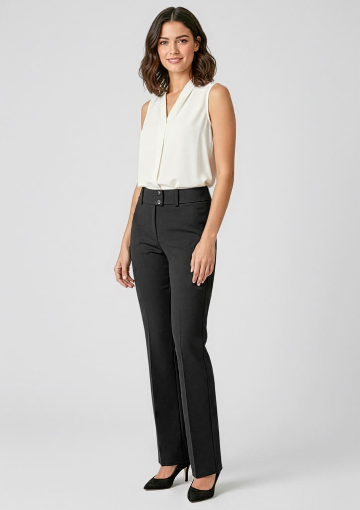 A model in a sleeveless white top and black slacks poses against a plain background. The slacks feature a logo. Womens Kate Perfect Pant - Image 1