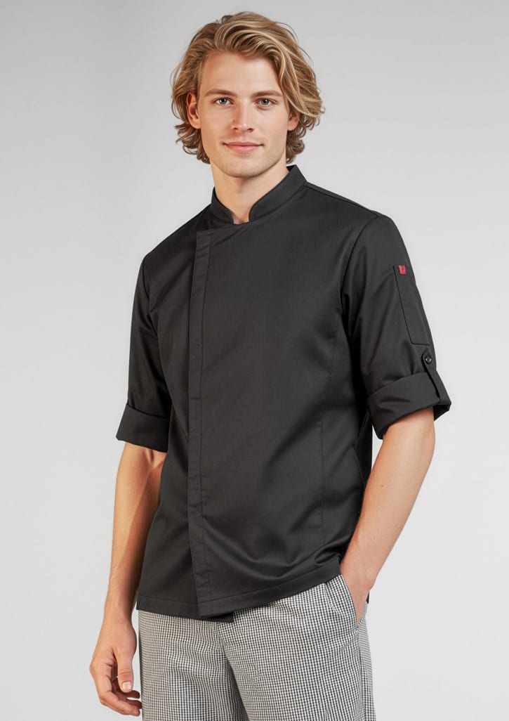 A black long sleeve chef jacket with rolled-up sleeves, modelled by a young man. It features a logo on one sleeve. Mens Alfresco Long Sleeve Chef Jacket - Image 1